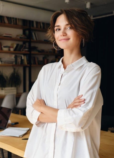 mulher de braços cruzados e olhar confiante